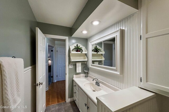 431 E Sunnyside Rd, Sandpoint, ID 83864 - bathroom featuring vanity, a decorative wall, a wainscoted wall, tile patterned flooring, and recessed lighting