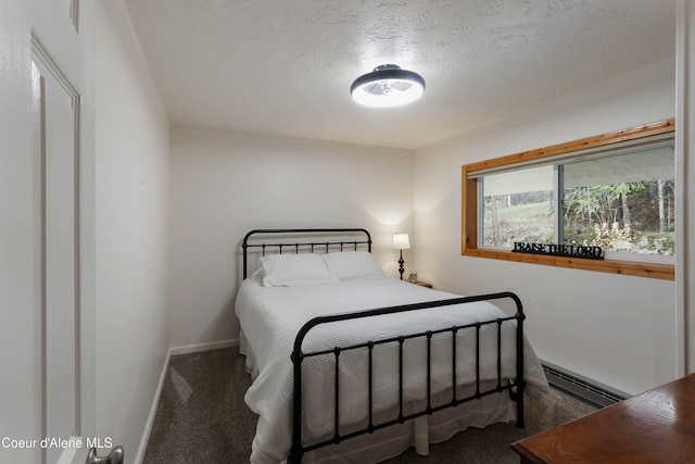 bedroom featuring a baseboard radiator, a textured ceiling, and dark colored carpet