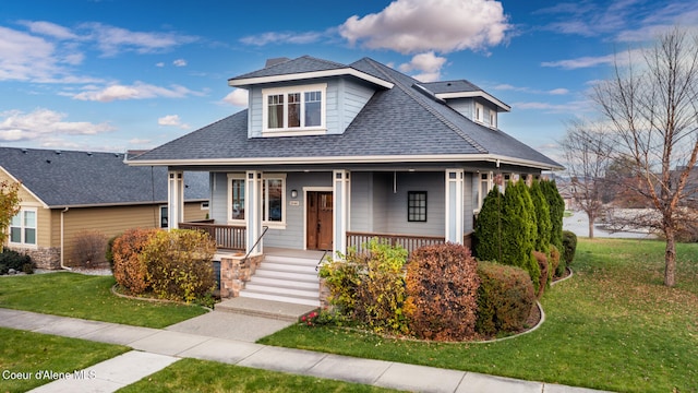 bungalow featuring a front lawn and a porch