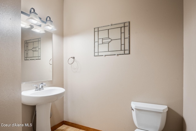 bathroom featuring toilet and sink