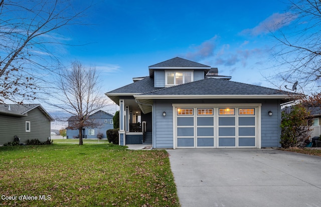 view of front of property with a front yard and a garage