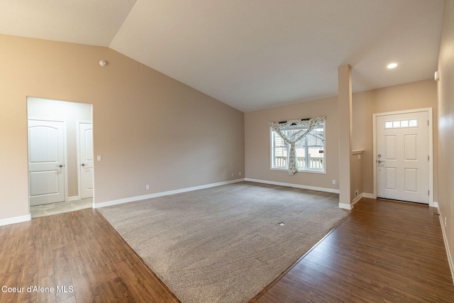 foyer entrance with dark hardwood / wood-style floors and vaulted ceiling