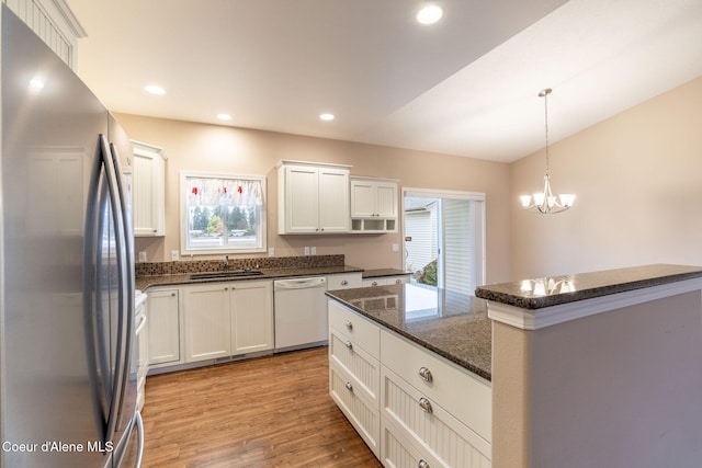 kitchen with white cabinets, dishwasher, light wood-type flooring, and stainless steel refrigerator