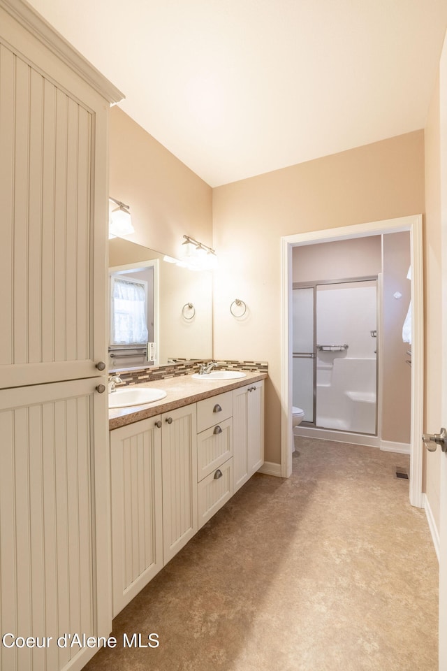 bathroom featuring vanity, toilet, and walk in shower