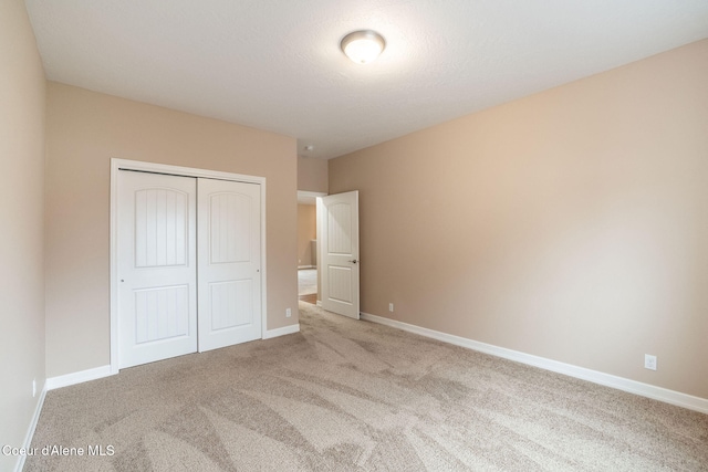 unfurnished bedroom with carpet and a closet