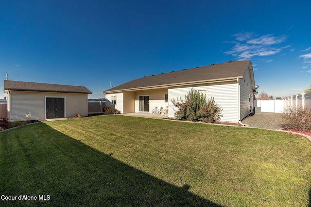 back of property with a yard, a patio area, central AC unit, and an outdoor structure