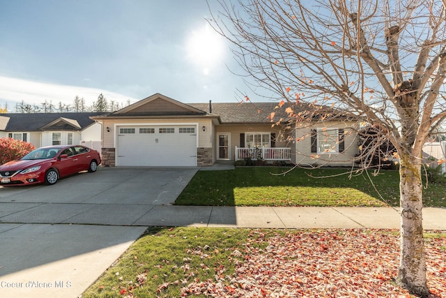 view of front of house featuring covered porch, a garage, and a front lawn