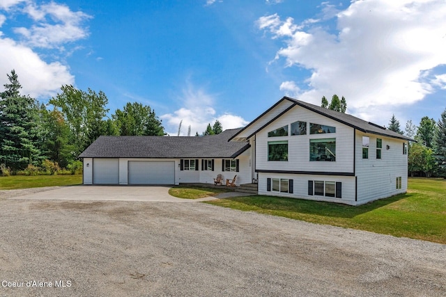 split level home with a front yard and a garage