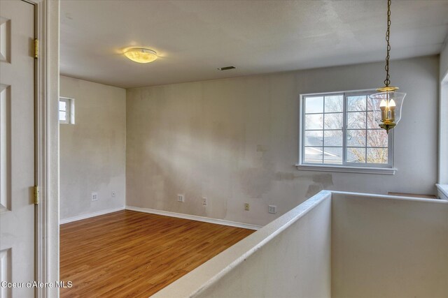 interior space featuring baseboards and wood finished floors
