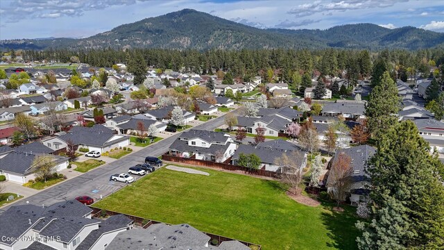 drone / aerial view with a residential view, a mountain view, and a forest view