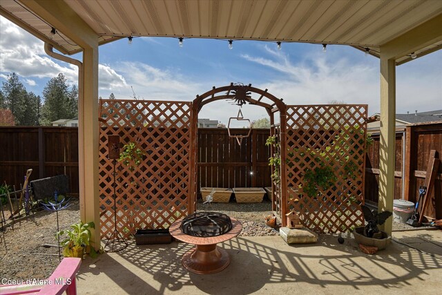 view of patio / terrace with a fire pit and a fenced backyard