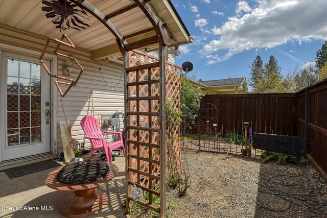 view of patio / terrace with fence and a fire pit
