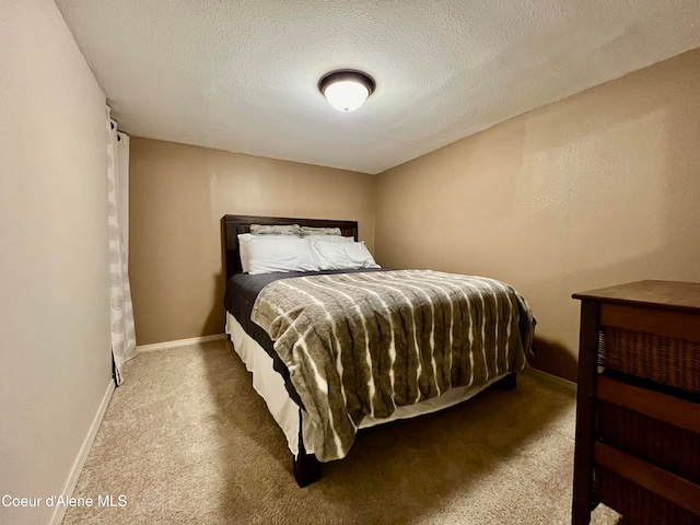 carpeted bedroom with a textured ceiling