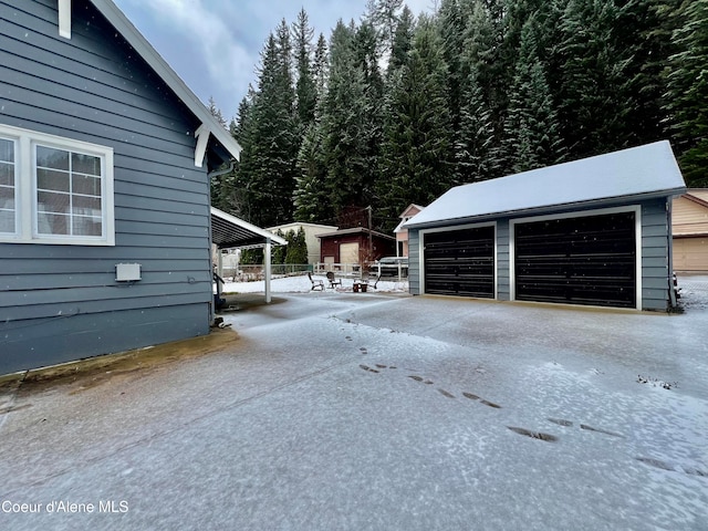 view of side of home featuring a garage and an outdoor structure