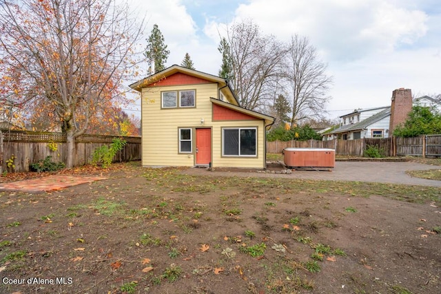 510 N Hubbard, Coeur Dalene, ID 83814 - back of property with a hot tub, a fenced backyard, and a patio