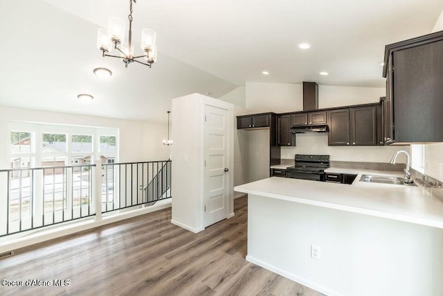 kitchen featuring sink, hanging light fixtures, black / electric stove, vaulted ceiling, and light wood-type flooring