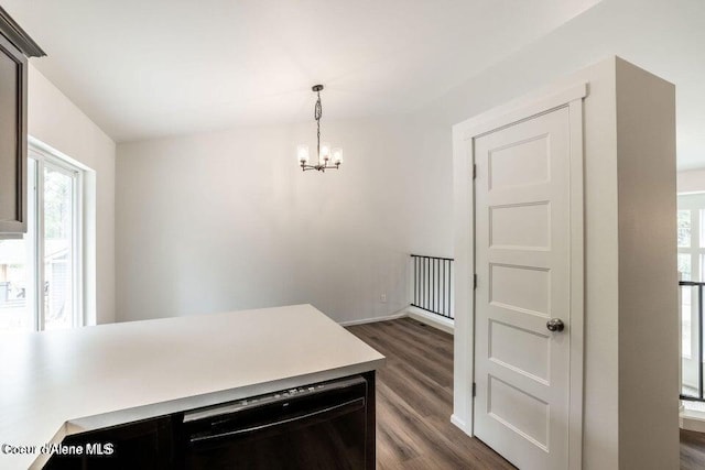 kitchen featuring decorative light fixtures, dark hardwood / wood-style floors, and an inviting chandelier