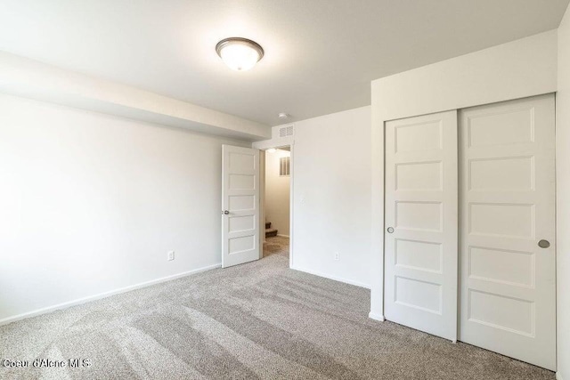 unfurnished bedroom with carpet and a closet