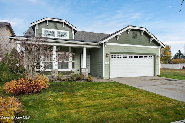 view of front of home with driveway, a front lawn, a porch, fence, and a garage