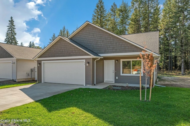 view of front of home with a garage and a front lawn