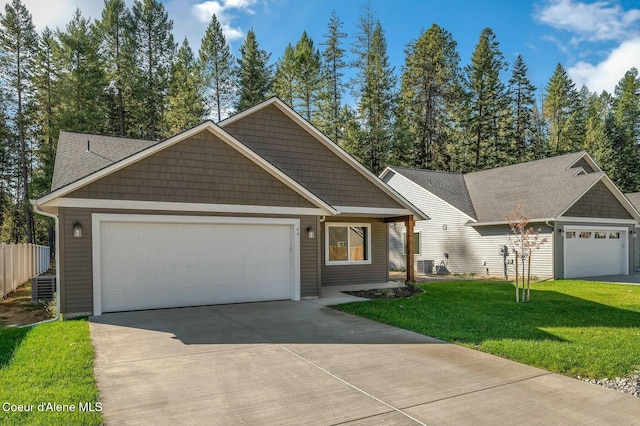 view of front of house featuring central AC, a front lawn, and a garage