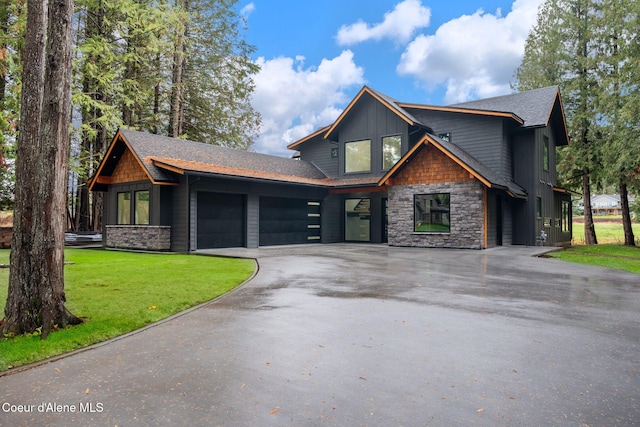 craftsman-style house with a garage and a front lawn