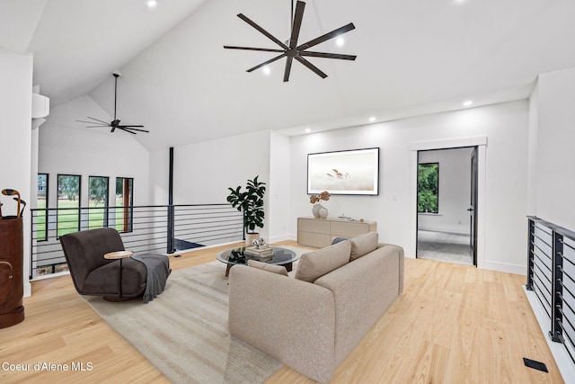 living area with baseboards, recessed lighting, a ceiling fan, high vaulted ceiling, and wood finished floors