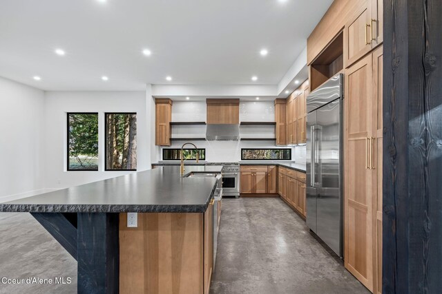 kitchen featuring built in refrigerator, concrete flooring, open shelves, recessed lighting, and dark countertops