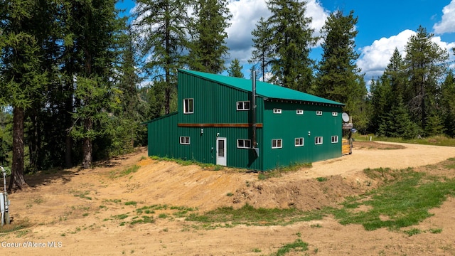 view of side of home featuring an outbuilding