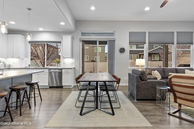 dining space with dark hardwood / wood-style floors and ceiling fan