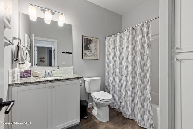 full bathroom with hardwood / wood-style flooring, vanity, shower / bath combination with curtain, and toilet