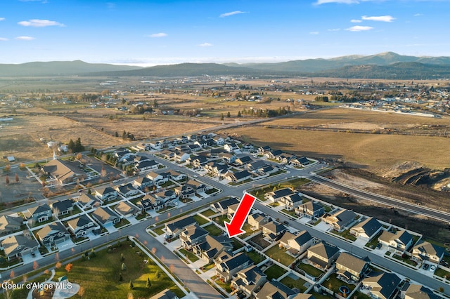 birds eye view of property with a mountain view