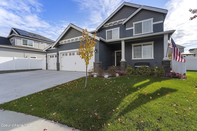 craftsman-style home with covered porch, a front yard, and a garage