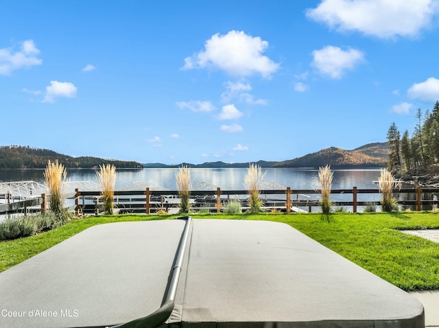 view of patio featuring a water and mountain view