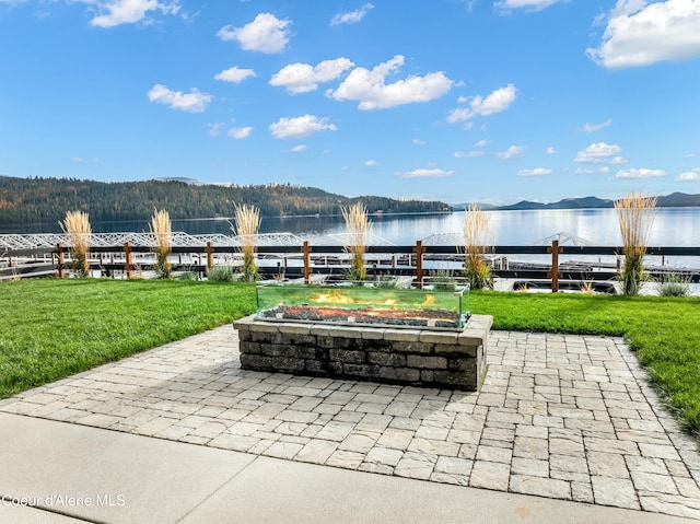 view of community with a yard and a water and mountain view