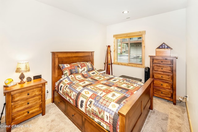 bedroom featuring light carpet