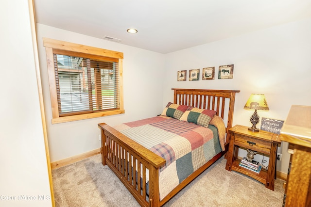 bedroom featuring light carpet