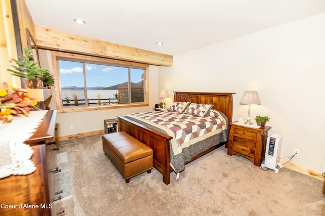 bedroom with a mountain view and light carpet