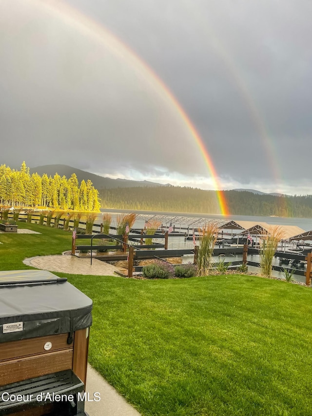 view of community featuring a lawn and a jacuzzi