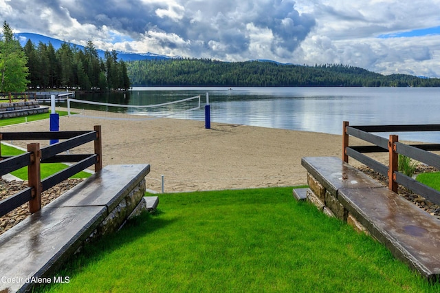 view of community with volleyball court and a water and mountain view