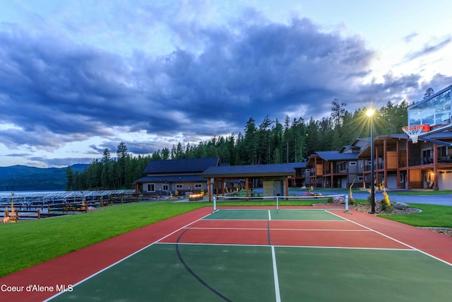 view of sport court with a mountain view, basketball court, and a lawn