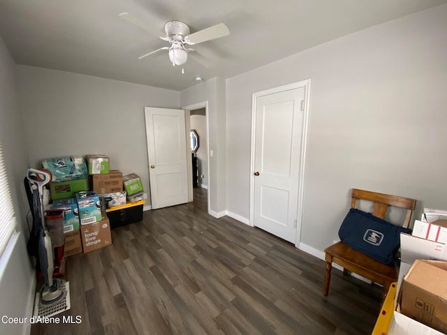 interior space with ceiling fan and dark hardwood / wood-style flooring