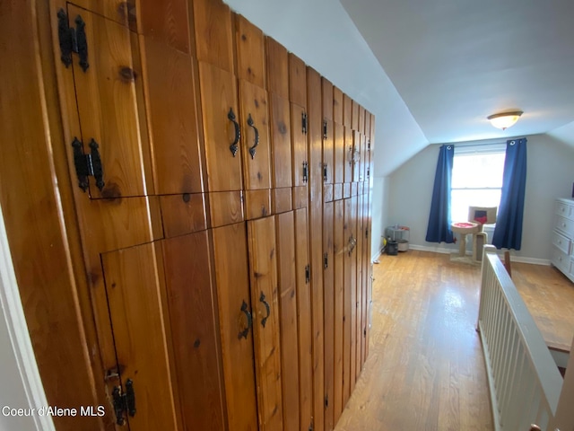 bonus room featuring vaulted ceiling and light wood-type flooring