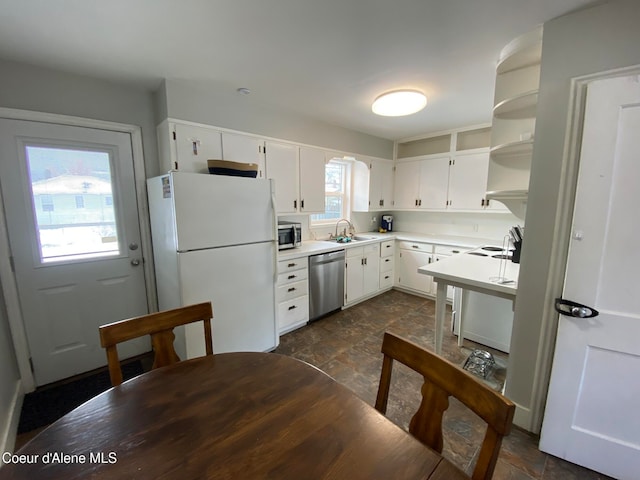 kitchen with white cabinets, appliances with stainless steel finishes, and sink