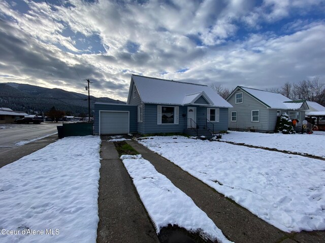 view of front facade with a mountain view and a garage