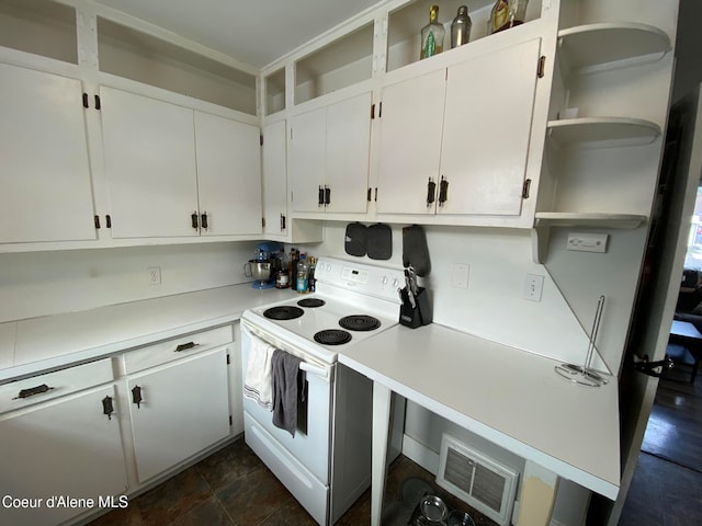 kitchen featuring white cabinetry and white electric stove