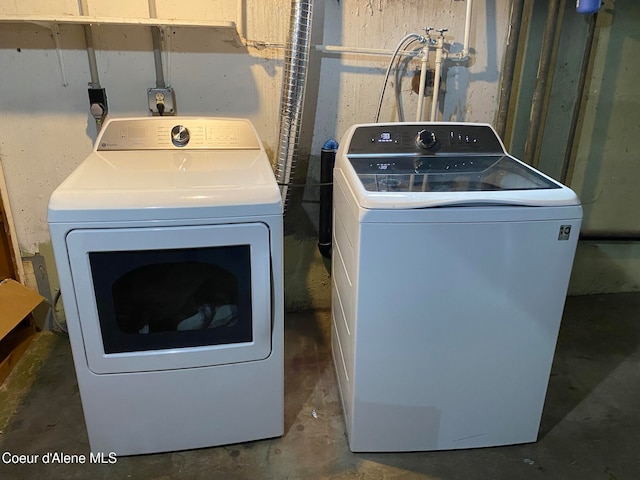 clothes washing area with washer and clothes dryer