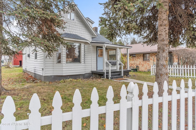 bungalow-style home with a front lawn