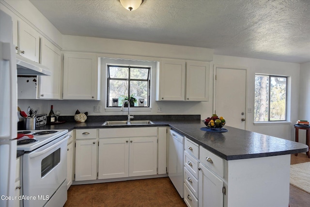 kitchen featuring white cabinetry, sink, a healthy amount of sunlight, and white appliances