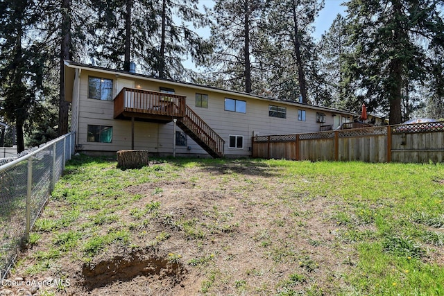 rear view of property with a lawn and a deck